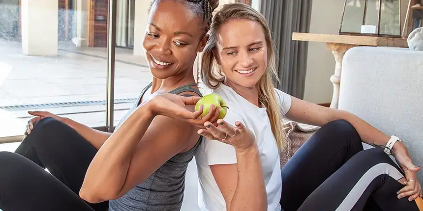 At-home personal trainer discussing nutrition and wellness in a client's kitchen